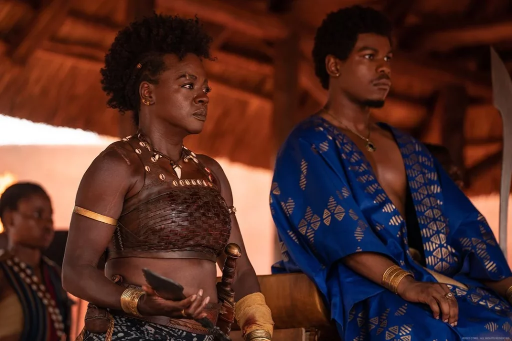 'The Woman King.' Viola Davis on the left as Nanisca and John Boyega on the right as King Ghezo