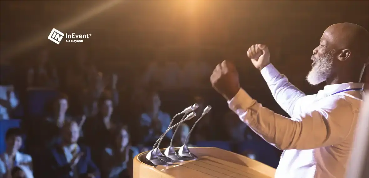 AN image of a man giving a speech with raised hands in a position of power
